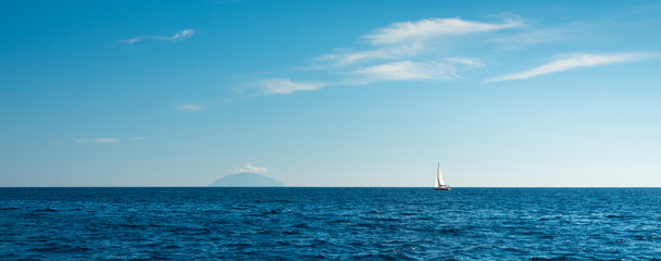 sea panorama with alone yacht and island