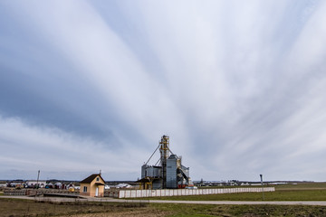 Fototapeta premium agro-processing and manufacturing plant for processing and silver silos for drying cleaning and storage of agricultural products, flour, cereals and grain. Granary elevator.
