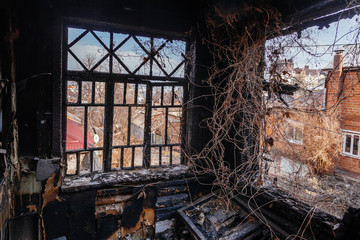 Burnt wooden house interior. Consequences of fire