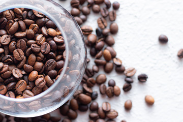 Coffee beans are scattered on a light background . Fresh coffee beans. Concept of advertising coffee, coffee beans, cafes.