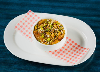Turkish dessert kunefe, kunafa, kadayif with pistachio powder and cheese, served hot, very sweet. Turkish traditional dessert.