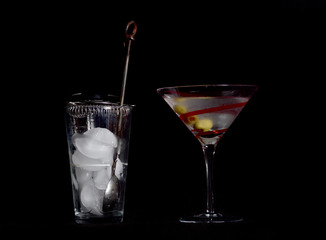 Martini on a Black Background, Stirred, Not Shaken, with Three Olives, and the Mixing Glass, Spoon,...