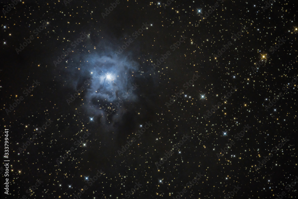 Wall mural the iris nebula, a reflection nebula glowing in the night sky, cornwall, uk