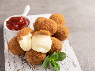 Breaded mozzarella cheese balls with tomato sauce