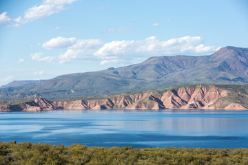 Roosevelt lake with cliffs and desert surrounding under a beautiful sky