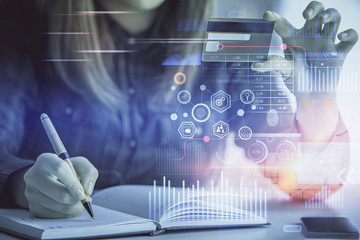 Double exposure of woman on-line shopping holding a credit card and data theme hologram drawing. E-commerce concept.