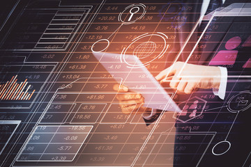 Double exposure of man's hand holding and using a digital device and data theme hologram drawing....