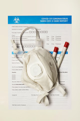 Face mask on form used for reporting of covid-19 coronavirus case