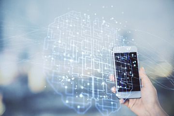 Double exposure of brain sketch hologram and woman holding and using a mobile device.