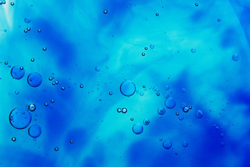 drops of oil on water and colorful blurred background