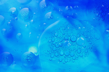 drops of oil on water and colorful blurred background