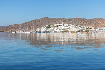 Adamas village with boats and mountain reflecting in Milos bay