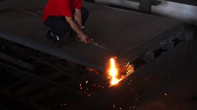 15. May. 2019 Turkey, Istanbul: Worker cutting metal, steel with acetylene torch in big factory.