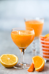 Freshly Made Organic Carrot-Orange Juice on grey background. Selective focus