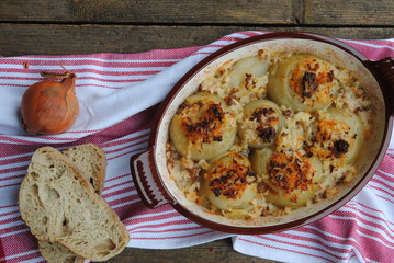 Roasted Onions, stuffed with Minced Meat and Rice, with some pieces of bread.