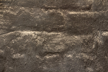close-up, brick wall covered with a thick layer of gilded paint