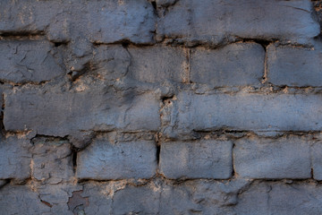 brick wall painted with gray paint with a blue tint