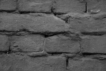brick wall painted black paint closeup for background