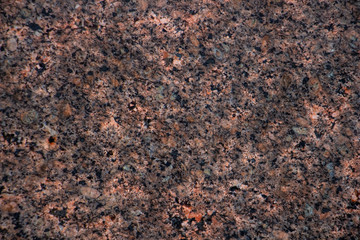 granite wall background closeup with orange hues