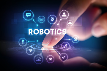 Finger touching tablet with web technology icons and ROBOTICS inscription, web technology concept