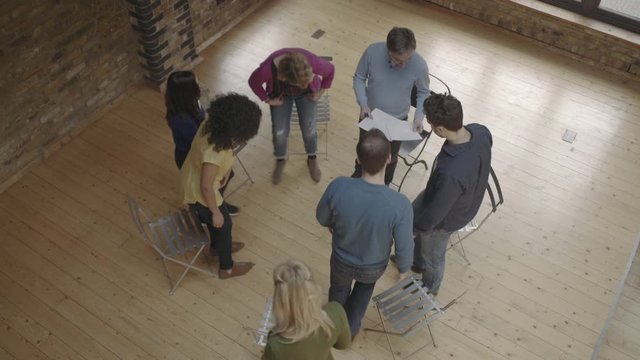 Group therapy session workshop, group sitting in circle