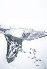 The water bottle falls into the water until the water is beautifully dispersed. Freshness on a white background.