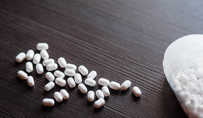 Candies lying on a wooden table. Background. Candy. Pills on the table. Many.