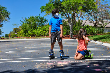coronavirus kids mask heads up side to side stare rollerblades pointing drawing chalk outside arts roller skates covid19