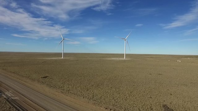 Aerial image of windmills powered by aerofoil that provide sustainable energy.