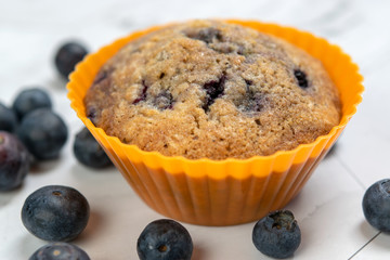 Close up of a blueberry muffin, in a colored silicone cake mold