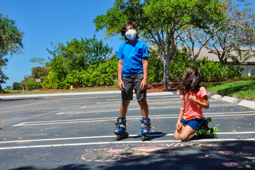 coronavirus kids mask heads up stare rollerblades pointing drawing chalk outside arts roller skates covid19