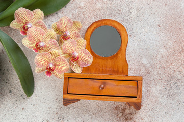 Vintage jewelry box in the shape of a dressing table and orchid flowers