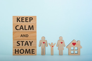 The text keep calm and stay home written on wooden blocks. People quarantined during a virus outbreak. The concept of self isolation during the virus Covid-19 epidemic.
