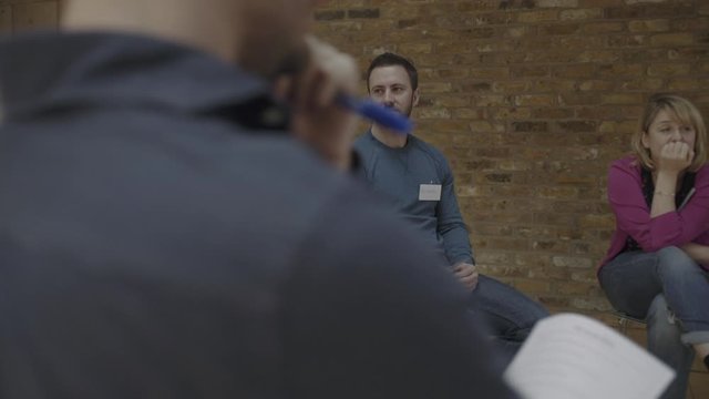 Adults Speaking in group therapy session