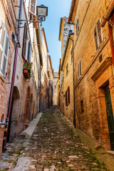 Fototapeta na wymiar View of a beautiful narrow steep street in Fermo, Province of Fermo, Marche Region, Italy