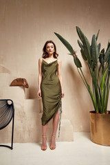 Fashion model brunette hair wear green silk dress sandals high heels accessory bag clothes for date...