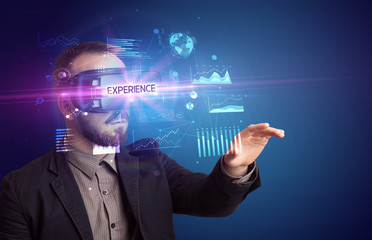 Obraz premium Businessman looking through Virtual Reality glasses with EXPERIENCE inscription, new business concept