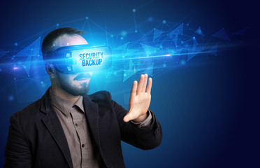 Businessman looking through Virtual Reality glasses with SECURITY BACKUP inscription, cyber security concept