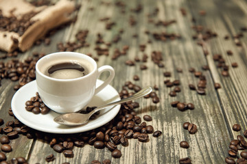 white cup of coffee on retro wooden table