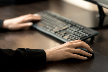 Remote work during quarantine. The girl works at the computer. Horizontal frame