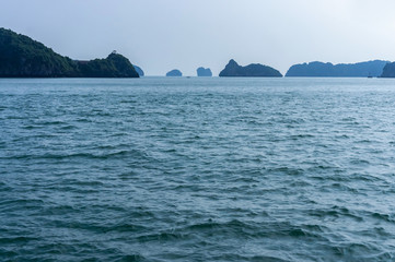 not sunny, foggy morning in Halong Bay, South China Sea, Vietnam, Southeast Asia, among limestone cliffs.