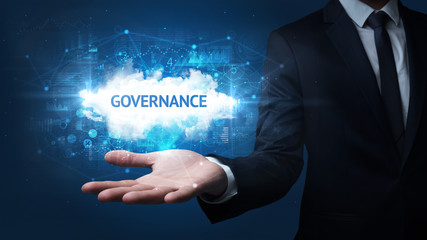 Hand of Businessman holding GOVERNANCE inscription, successful business concept