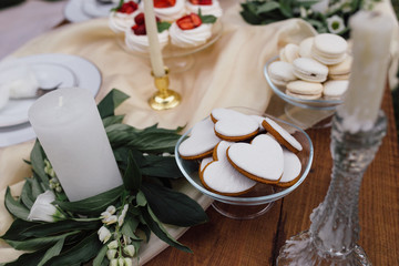 Sweet dessert table or candy bar. Wedding party. Natural light. Macaron and meringue pyramid. Cupcakes and marshmallow.