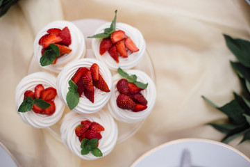 beautiful fruit dessert, fruit cake with strawberries and cream .
