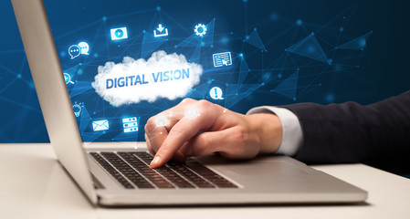 Businessman working on laptop with DIGITAL VISION inscription, modern technology concept