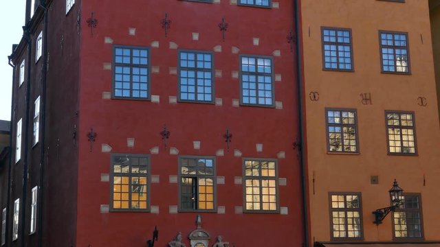 Left to right pan over old colorful houses in Stortorget Public Square, Gamla Stan in Sweden Stockholm
