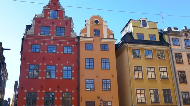 Right to left pan over old colorful houses in Stortorget Public Square, Gamla Stan in Sweden Stockholm