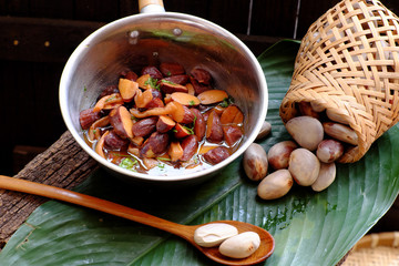 pot of jackfruit seeds cook with sauce, Vietnamese homemade vegan food from nut for vegetarian meal