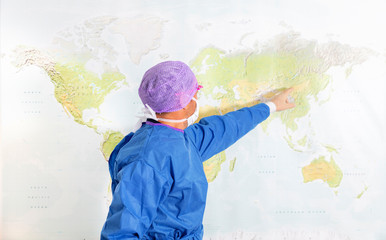 Doctor pointing at world map