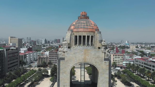 Panoramic aerial shot zooming in on the Revolution Monument, the Revolution Square and buildings in the background. During the covid-19 pandemic contingency in March 2020